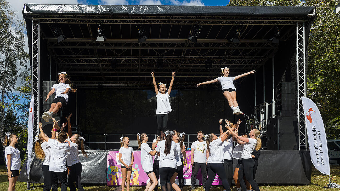 Die Cheerleader des TSV Wittenau zeigen Hebefiguren vor der Bühne.