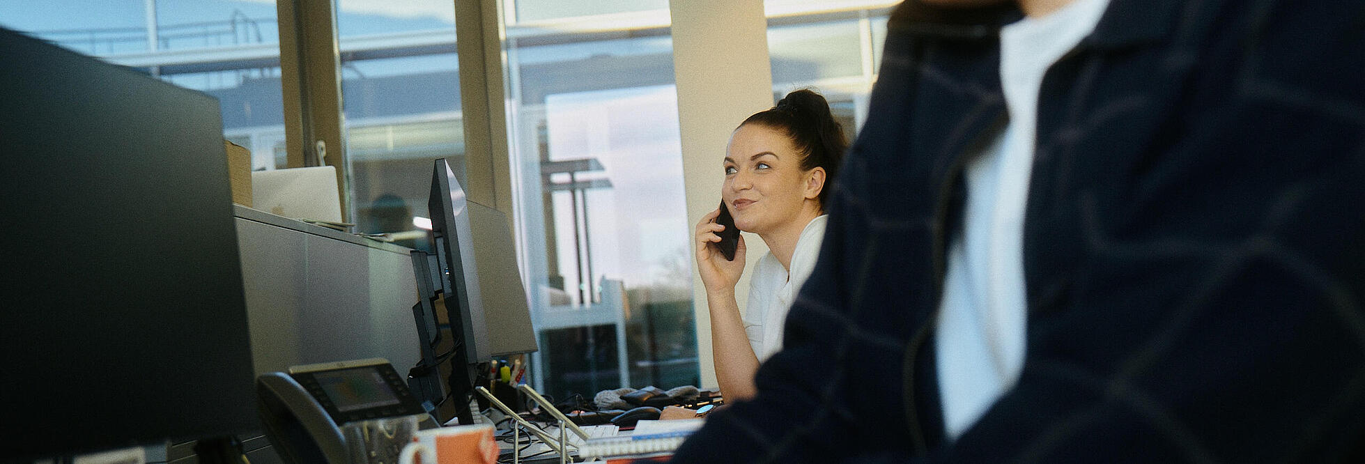 Innenaufnahme zeigt zwei Mitarbeitende der GESOBAU bei der Arbeit im Büro.